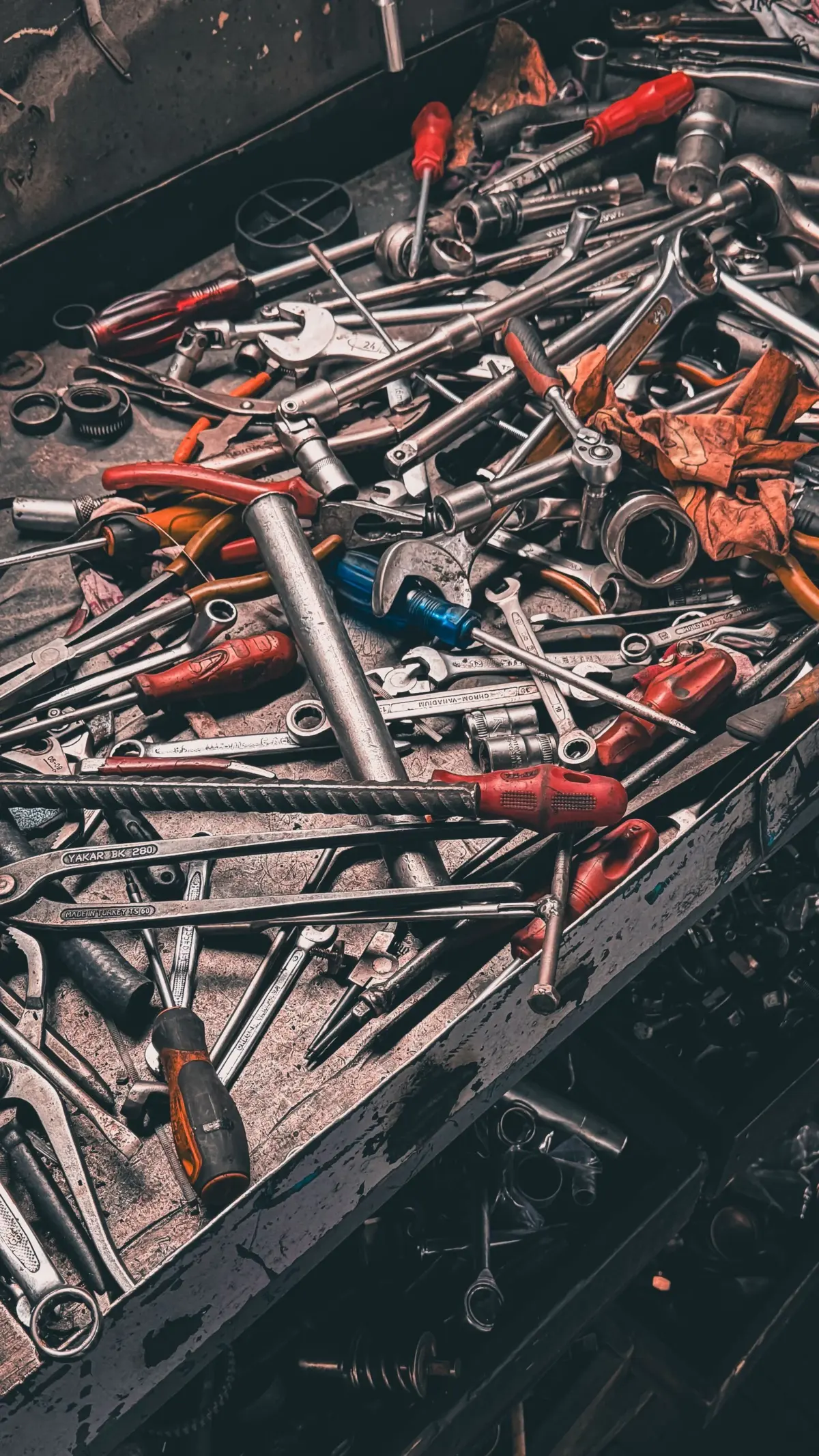 Hand tools laid out on a garage workbench